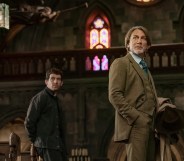 Wake Up Dead Man Josh O'Connor standing behind Daniel Craig in a church.