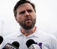 JD Vance, pictured speaking into a set of microphones.