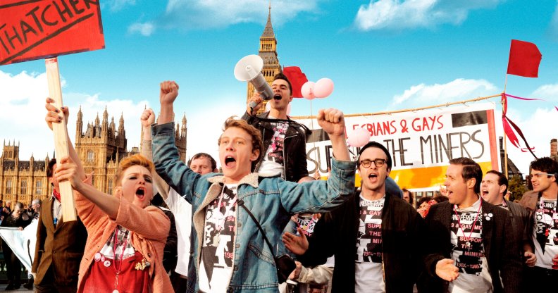 Image shows group of people protesting in support of the miners - waving placards