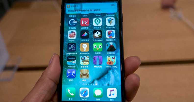 A customer is trying an iPhone 7 in an Apple Store.