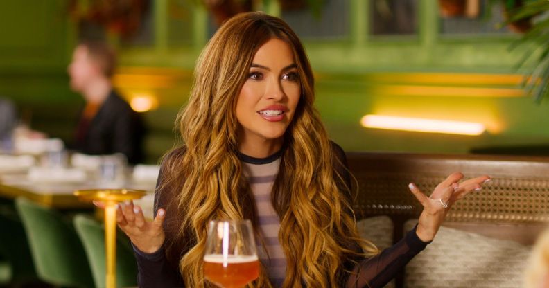 Chrishell Stause raises her hands in an 'i don't know' pose in a still from Selling Sunset.