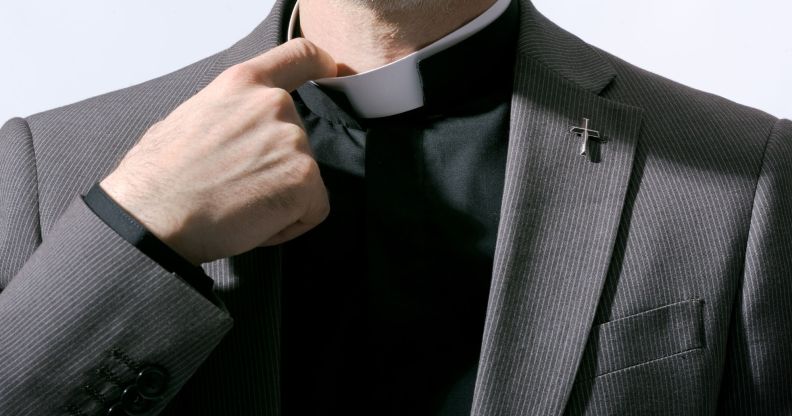 A pastor tugging at his collar.