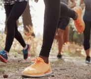 A photo of the lower torsos of a group of runners.