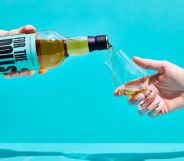 An unpictured person pouring a bottle of the For the Dolls whisky.