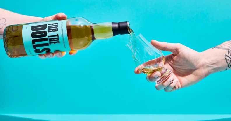 An unpictured person pouring a bottle of the For the Dolls whisky.