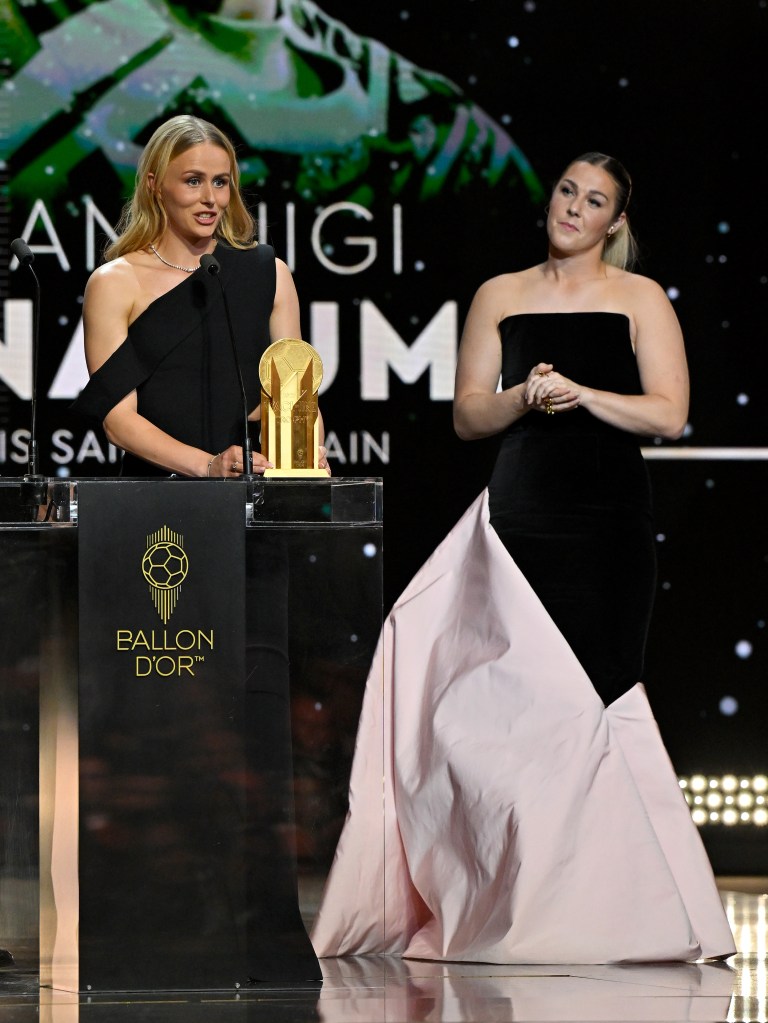 Hannah Hampton speaks on stage with the Women's Yashin Trophy alongside Mary Earps during the 69th Ballon D'Or Ceremony