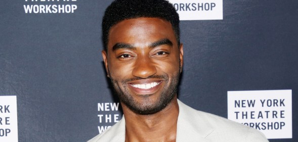 Jelani Alladin posing in a cream suit