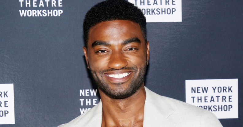 Jelani Alladin posing in a cream suit