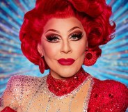 La Voix in all red in front of a blue strictly background