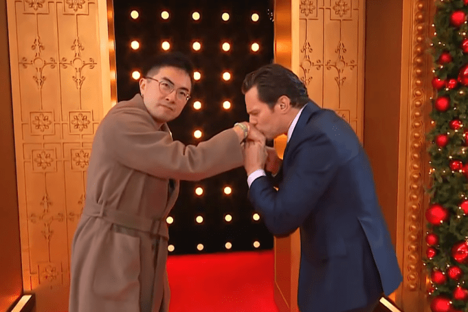 Bowen Yang and Jonathan Groff share a kiss at the parade.