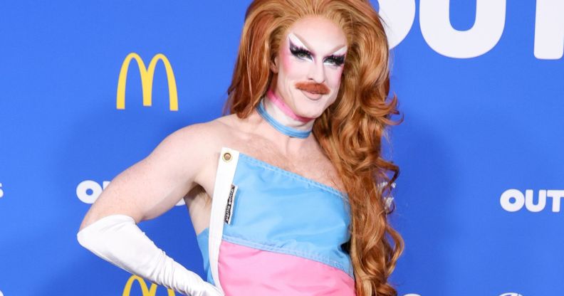 Pattie Gonia in her trans flag dress.