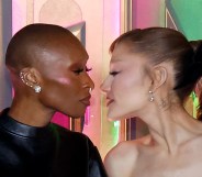 Cynthia Erivo and Ariana Grande leanming in to walkt to each other at the Wicked: For Good! premiere