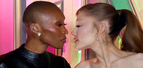 Cynthia Erivo and Ariana Grande leanming in to walkt to each other at the Wicked: For Good! premiere