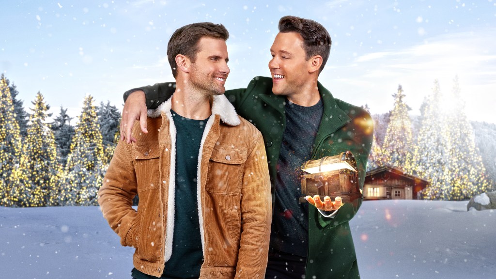 A Christmas to Treasure still: two men side-hugging with one holding a glowing chest.