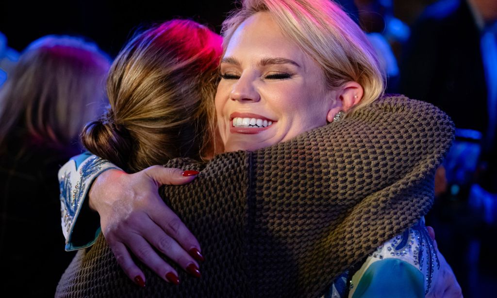 Aftyn Behn hugging someone.