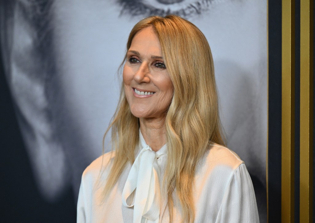 Celine Dion smiling in a white shirt