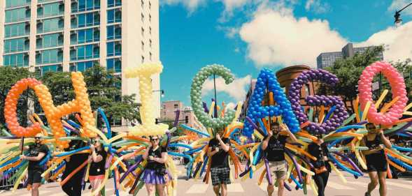 Participants carrying balloons spelling out "Chicago" during the 53rd annual Chicago Pride Parade on 30 June, 2024, in Chicago, Illinois.