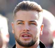 Chris Hughes watches the racing as he attends day 1 'Champion Day' of the Cheltenham Festival at Cheltenham Racecourse on March 12, 2019 in Cheltenham, England.