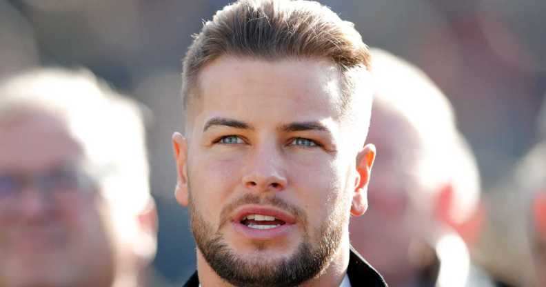 Chris Hughes watches the racing as he attends day 1 'Champion Day' of the Cheltenham Festival at Cheltenham Racecourse on March 12, 2019 in Cheltenham, England.