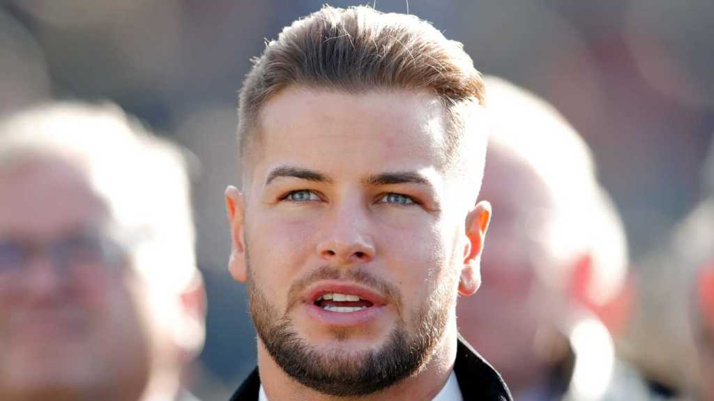 Chris Hughes watches the racing as he attends day 1 'Champion Day' of the Cheltenham Festival at Cheltenham Racecourse on March 12, 2019 in Cheltenham, England.