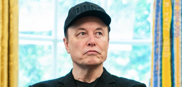Elon Musk looks on during a news conference with US President Donald Trump in the Oval Office