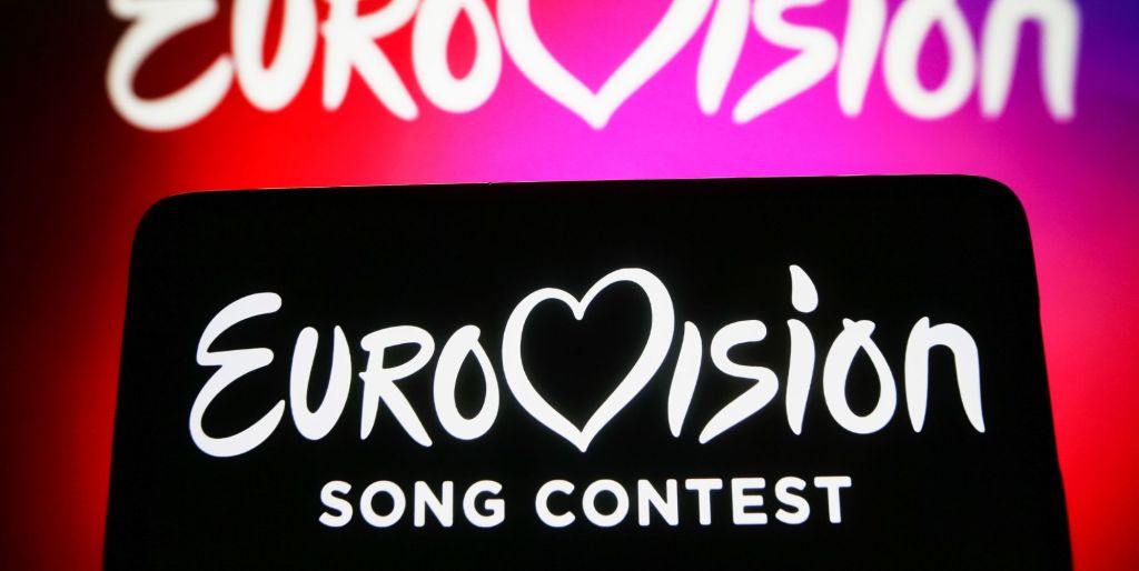 Eurovision Song Contest (ESC) logo is seen on a smartphone and on a pc screen.