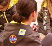 A group of Girlguiding Brownies sat doing arts and crafts.
