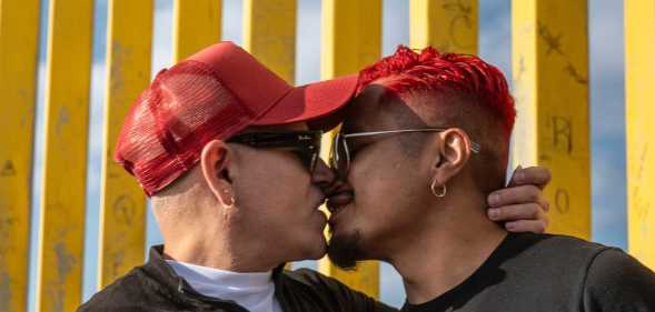 Participants kiss at MPact Global’s International HIV Kiss-In at Friendship Park.