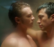 Heated Rivalry (L to R) - Connor Storrie as Ilya Rozanov and Hudson Williams as Shane Hollander. The pair are standing with their bodies pressed together in the shower.