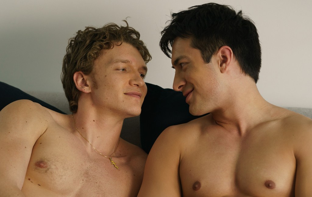 Ilya Rozanov (Connor Storrie) and Shane Hollander (Hudson Williams) shirtless in bed together.