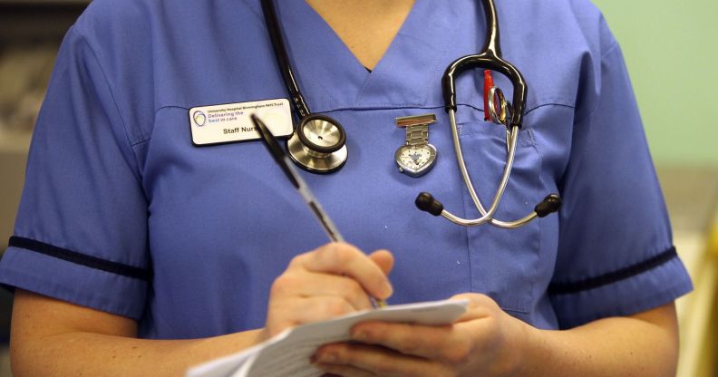 A nurse writing on a document.