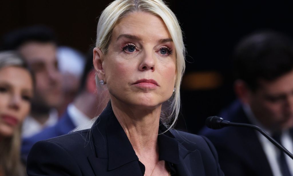 A portrait image of US attorney general Pam Bondi in a black suit.