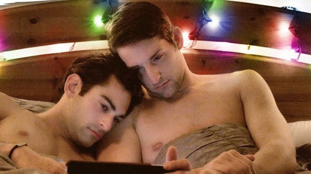 Shared Rooms still: two men cuddled in bed