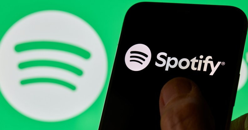 Close-up images show the Spotify logo and mobile application interface on a smartphone screen.