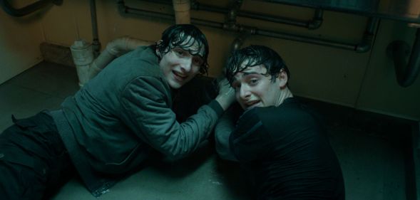 Finn Wolfhard and Noah Schnapp on a bathroom floor in Stranger Things season five.