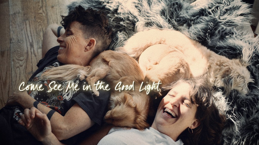 Come See Me in the Good Light still: two people lying on the floor beside their dogs
