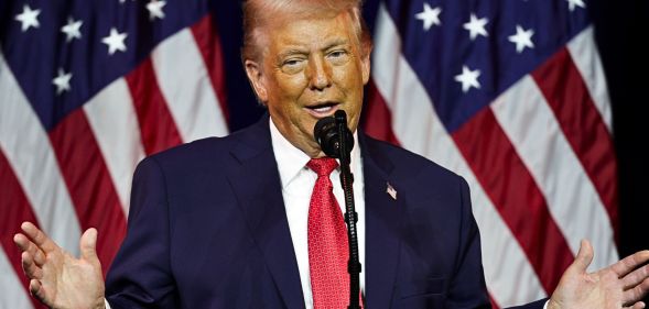 US president Donald Trump speaking at a podium.