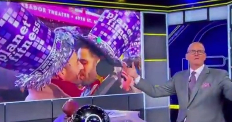 Scott Van Pelt goes viral for his reaction to a gay kiss. Image of the host in his studio with the gay New Year's Eve kiss on the screen behind him