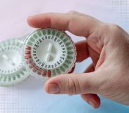 Someone holding a HRT pill capsule.