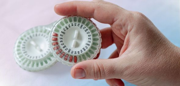 Someone holding a HRT pill capsule.
