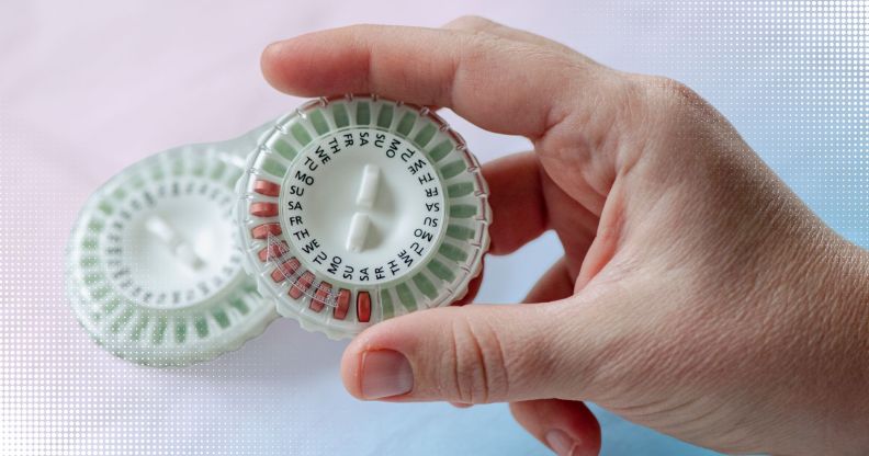 Someone holding a HRT pill capsule.