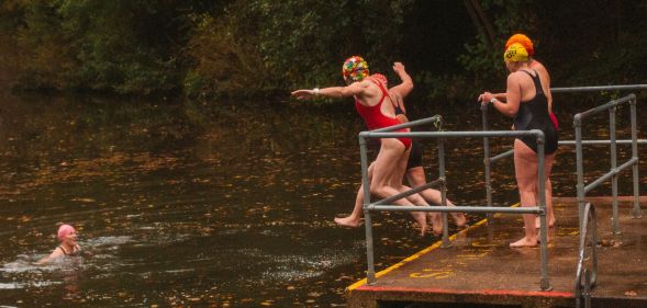Women jumping into Kenwood Ladies' Pond in Hampstead Heath.