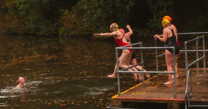 Women jumping into Kenwood Ladies' Pond in Hampstead Heath.