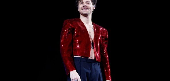 Harry Styles on tour in a shiny red jacket