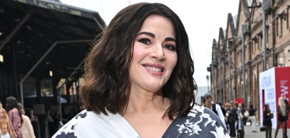Nigella Lawson wearing a white and black floral dress, smiling at the camera