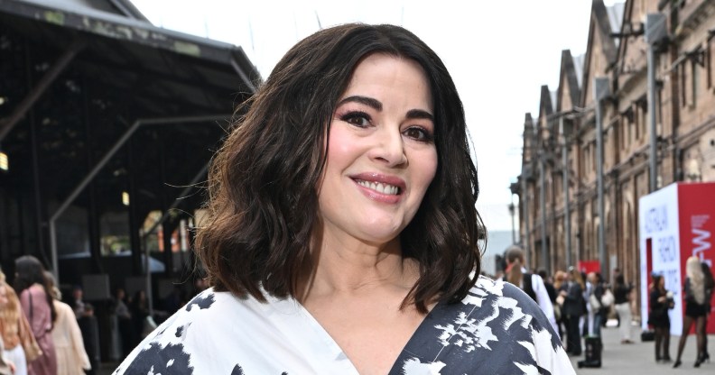 Nigella Lawson wearing a white and black floral dress, smiling at the camera