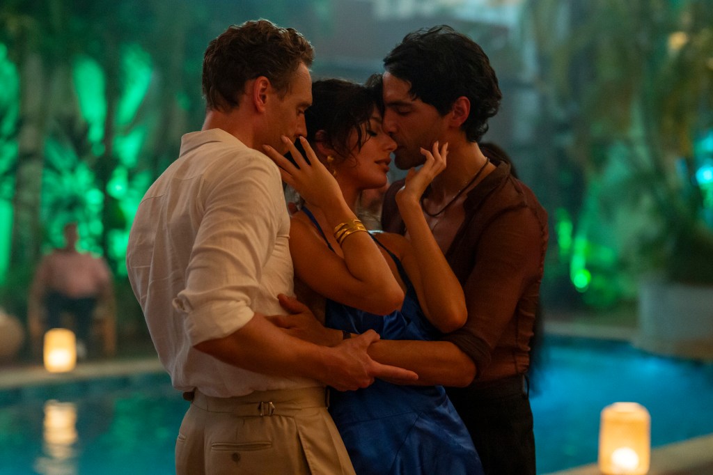 The Night Manager still: Tom Hiddleston as Jonathan Pine, Camila Morrone as Roxana and Diego Calva as Teddy. The three pressed close together dancing