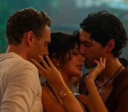 The Night Manager still: Tom Hiddleston as Jonathan Pine, Camila Morrone as Roxana and Diego Calva as Teddy. The three pressed close together dancing