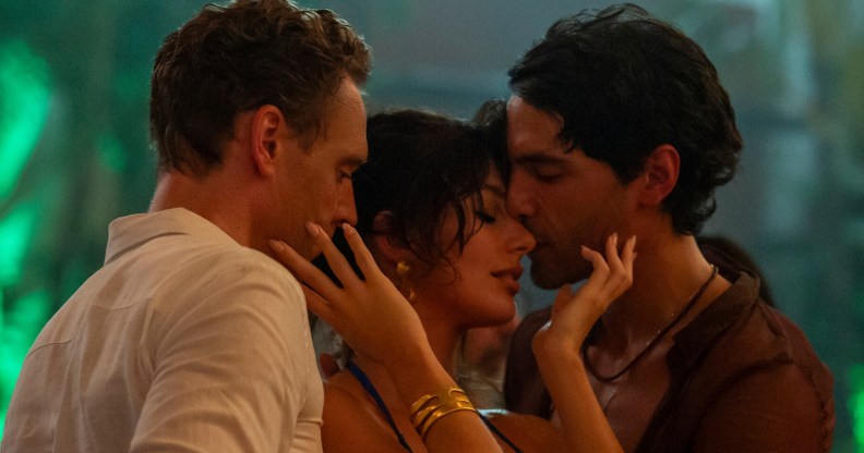 The Night Manager still: Tom Hiddleston as Jonathan Pine, Camila Morrone as Roxana and Diego Calva as Teddy. The three pressed close together dancing