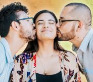 Two people kissing one person.